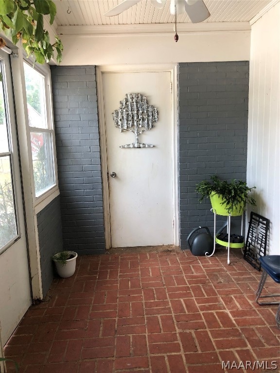 doorway to property featuring ceiling fan