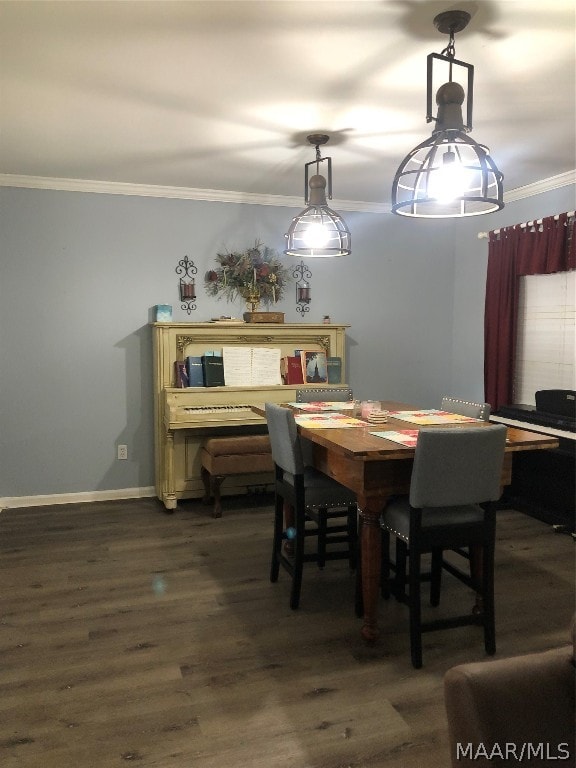 dining area with hardwood / wood-style flooring and ornamental molding