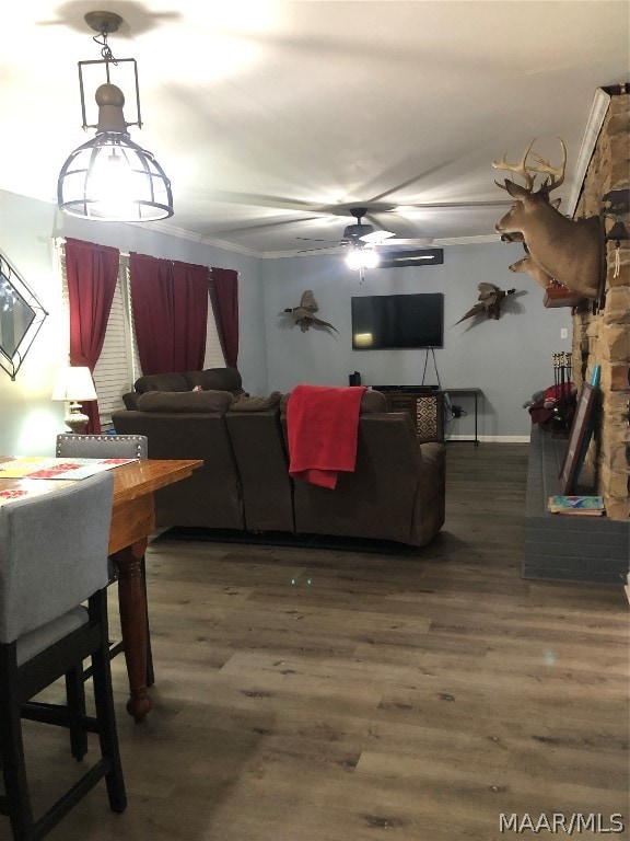 living room featuring hardwood / wood-style floors and ceiling fan