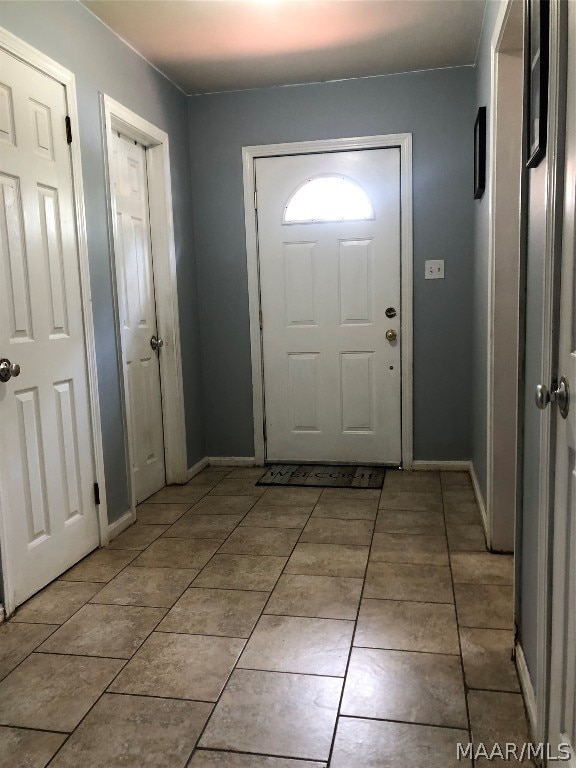 entryway featuring light tile patterned flooring