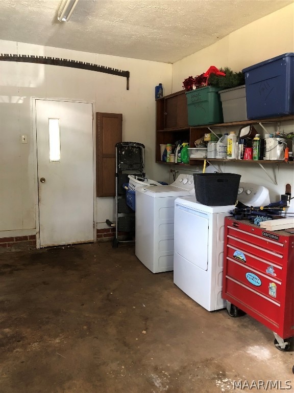 washroom featuring a textured ceiling and washing machine and clothes dryer