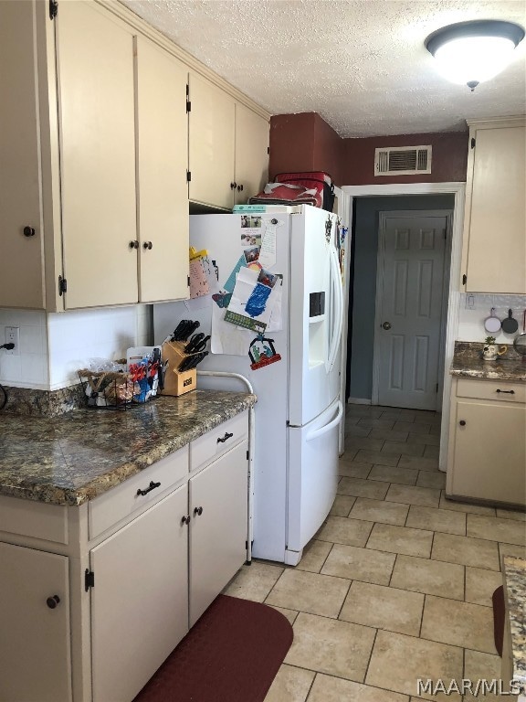 kitchen featuring light tile patterned floors and a textured ceiling