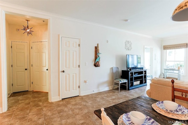 living room with crown molding and a chandelier