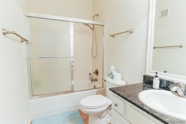 full bathroom featuring bath / shower combo with glass door, vanity, and toilet