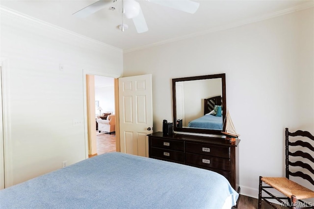 bedroom with ornamental molding, hardwood / wood-style floors, and ceiling fan