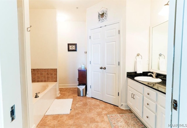 bathroom with vanity, a bath, and tile patterned floors