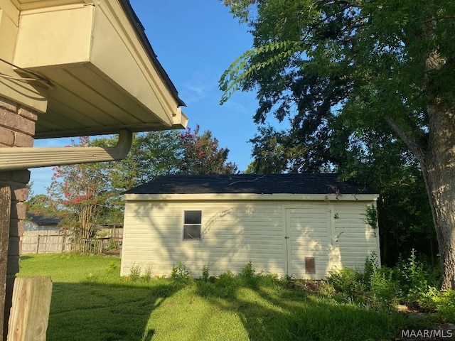 view of side of property with a storage shed and a lawn