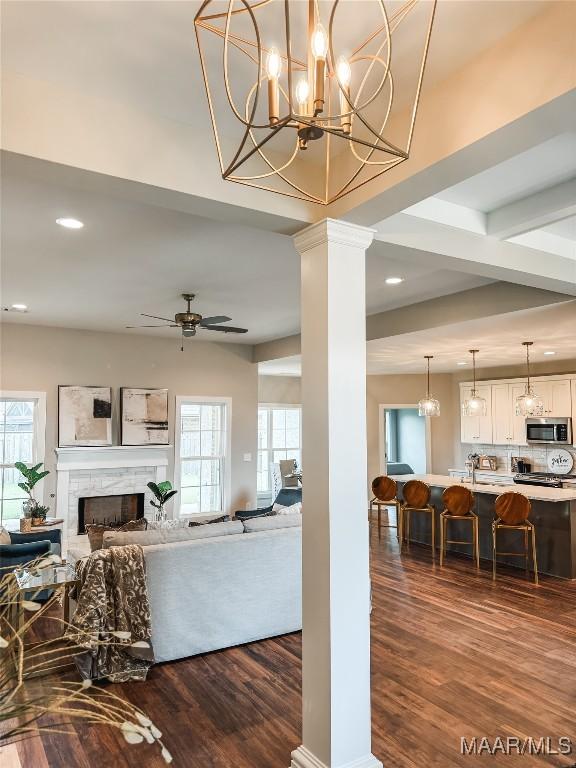 1379 Barret Park Way, Montgomery, AL 36117 - living area featuring dark wood-style floors, recessed lighting, plenty of natural light, ornate columns, and a fireplace
