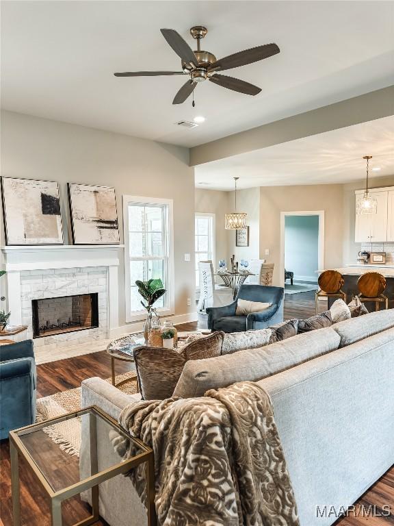 1379 Barret Park Way, Montgomery, AL 36117 - living room with dark wood finished floors, a stone fireplace, a ceiling fan, and recessed lighting