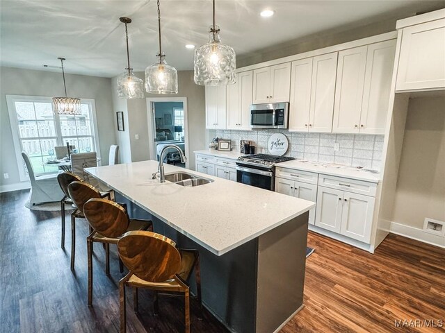 1379 Barret Park Way, Montgomery, AL 36117 - kitchen featuring stainless steel appliances, a sink, baseboards, dark wood-type flooring, and recessed lighting