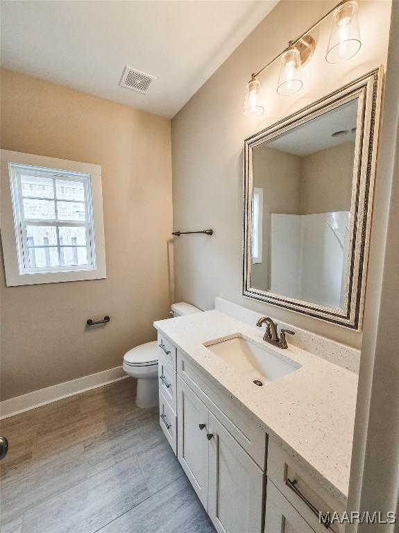 1379 Barret Park Way, Montgomery, AL 36117 - bathroom featuring toilet, vanity, baseboards, and wood finished floors