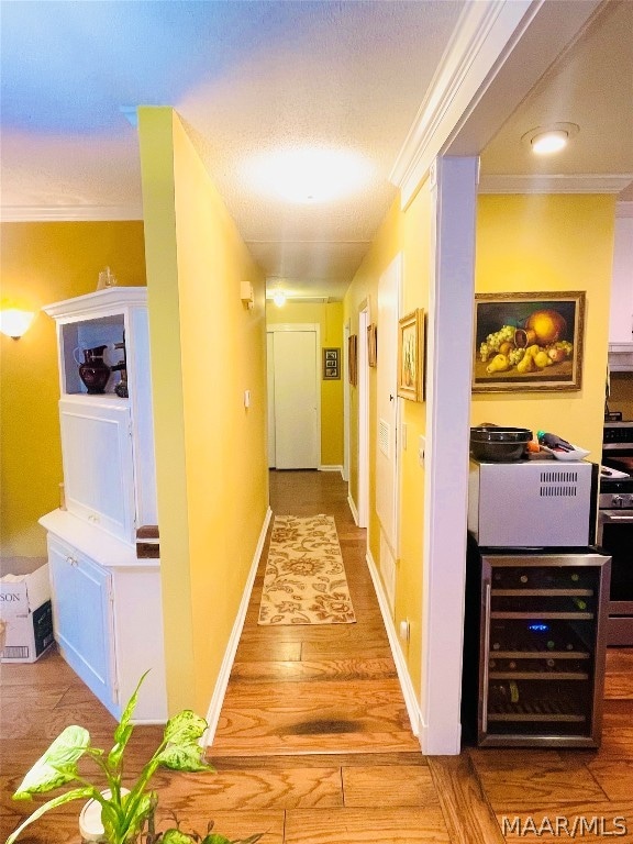 hallway featuring wood-type flooring and ornamental molding