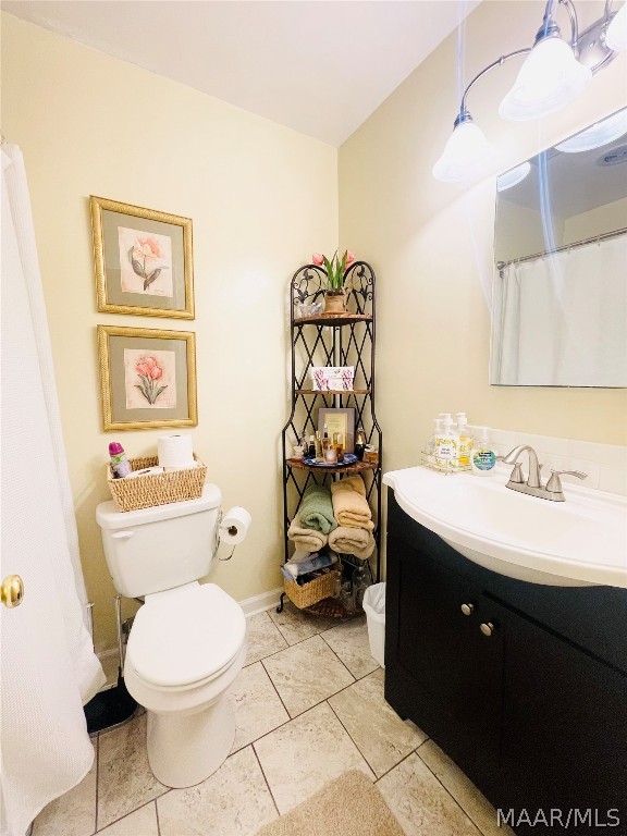 bathroom featuring vanity, toilet, and walk in shower