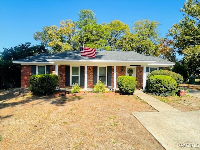 single story home featuring covered porch