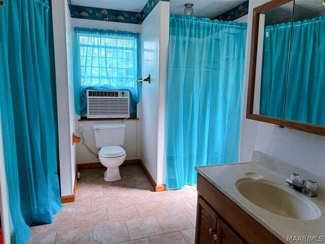 bathroom featuring toilet, vanity, and cooling unit