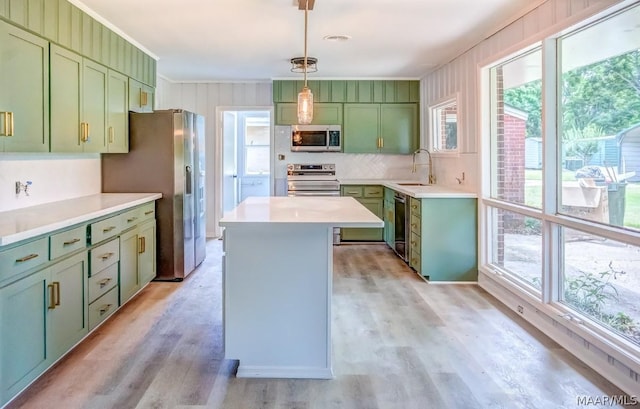 kitchen featuring pendant lighting, green cabinetry, appliances with stainless steel finishes, and sink