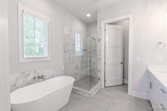 bathroom with vanity and separate shower and tub