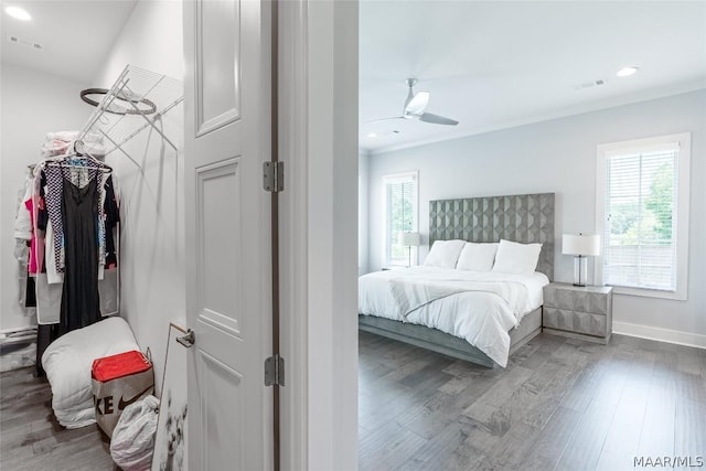 bedroom featuring hardwood / wood-style flooring, ceiling fan, and ornamental molding