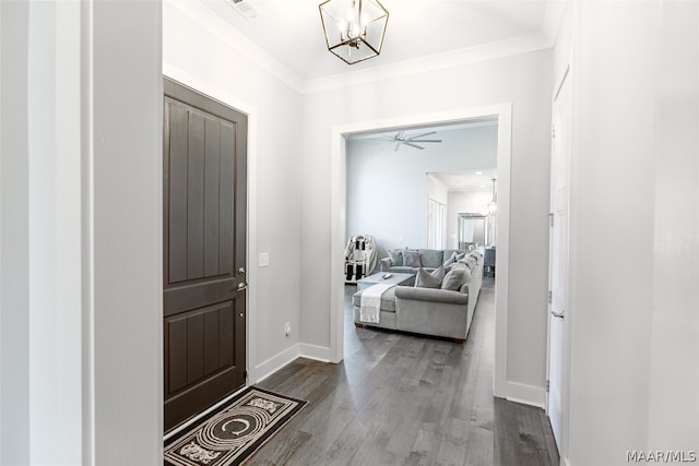 entrance foyer featuring ceiling fan with notable chandelier, crown molding, and hardwood / wood-style floors