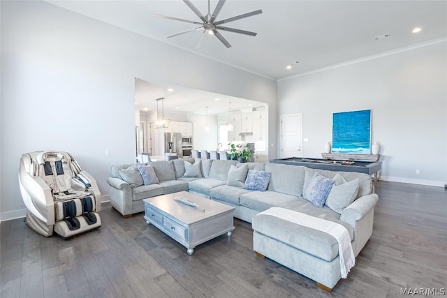 living room with crown molding, ceiling fan, and dark hardwood / wood-style flooring