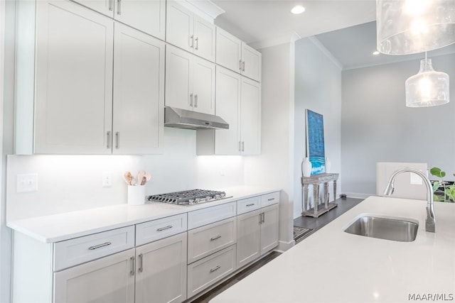 kitchen featuring decorative light fixtures, sink, white cabinets, stainless steel gas cooktop, and crown molding