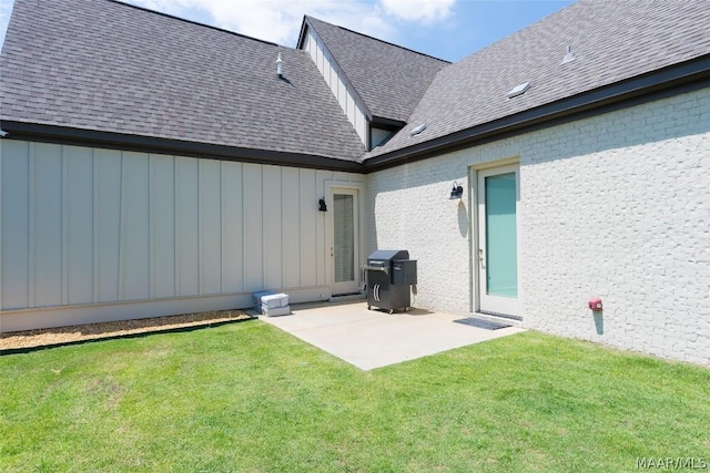 back of property featuring a lawn and a patio