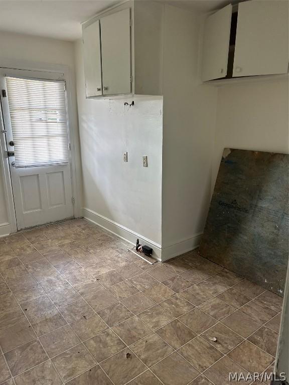 laundry room featuring baseboards