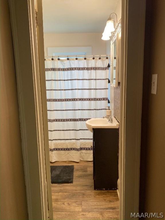 bathroom featuring vanity, wood-type flooring, and a shower with curtain