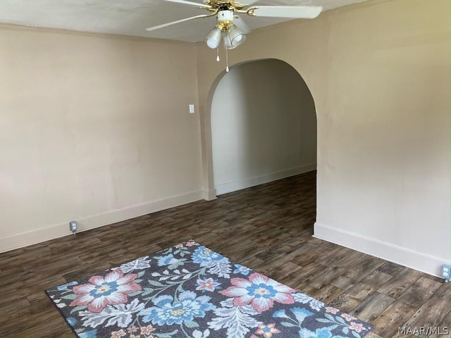 empty room featuring ceiling fan and dark hardwood / wood-style flooring