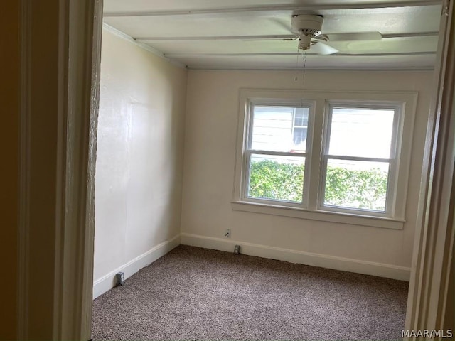 carpeted spare room with ceiling fan