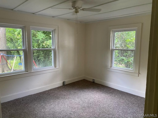 spare room featuring ceiling fan, a wealth of natural light, and carpet flooring