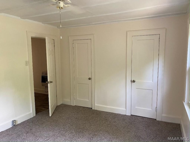 unfurnished bedroom featuring heating unit and carpet flooring