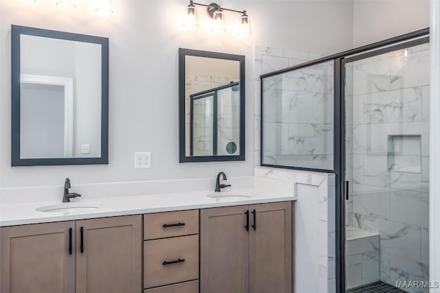 bathroom with double vanity, a stall shower, and a sink