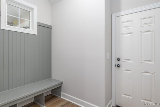 mudroom with wood finished floors and baseboards