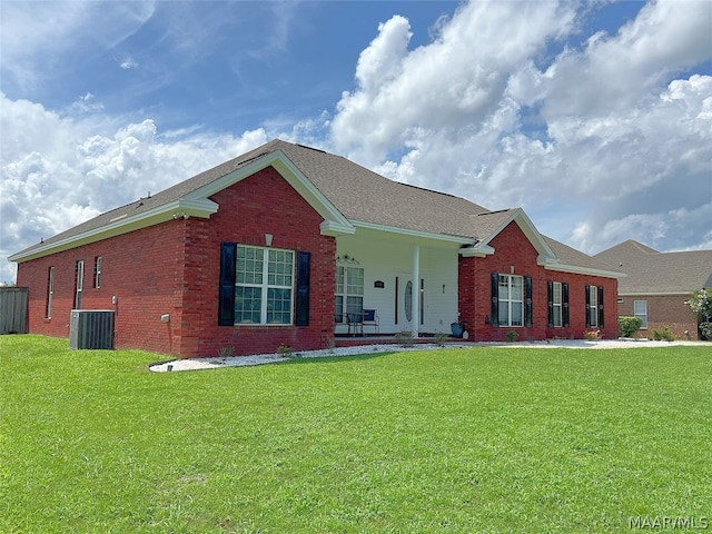 ranch-style house featuring a porch, cooling unit, and a front lawn