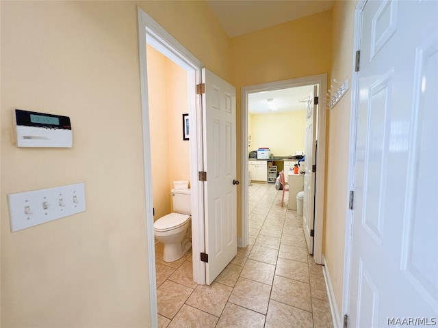 interior space featuring toilet and tile patterned flooring