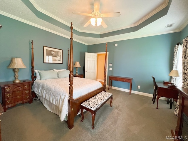 bedroom with ornamental molding, carpet flooring, ceiling fan, and a tray ceiling