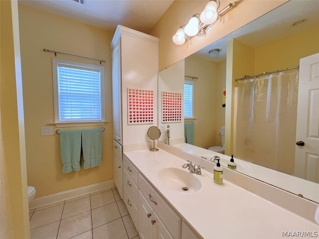 bathroom featuring vanity, tile patterned floors, and toilet