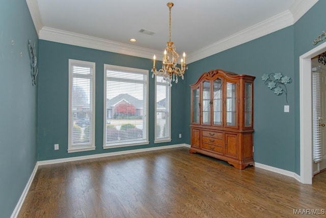 unfurnished dining area with a notable chandelier, ornamental molding, and dark hardwood / wood-style floors