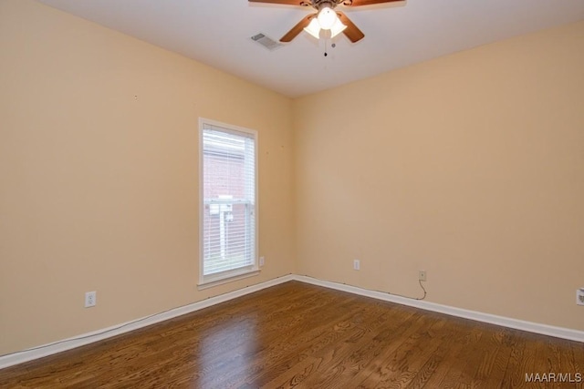 spare room featuring ceiling fan and dark hardwood / wood-style floors