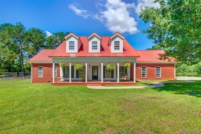 new england style home with a porch and a front lawn