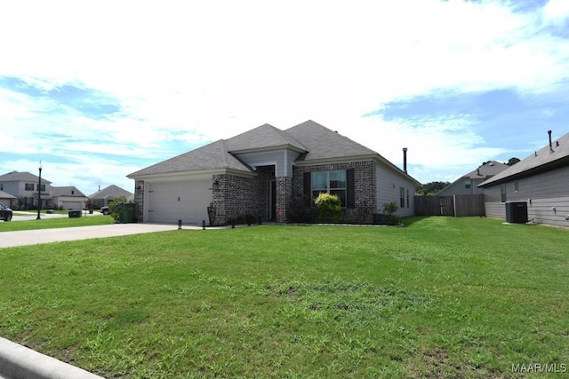 view of front of property with cooling unit, a front yard, and a garage