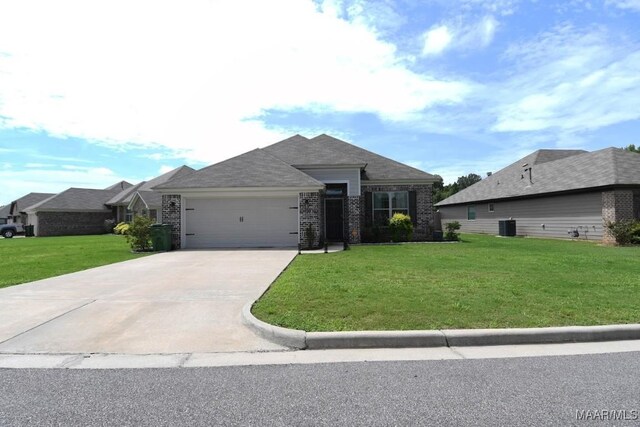 view of front of property with a front yard and a garage