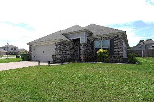 view of front of property with a garage and a front lawn