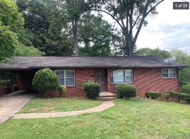 single story home featuring a carport and a front lawn