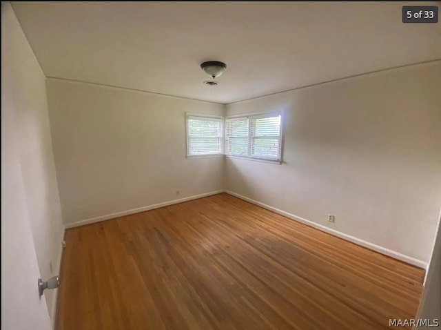 empty room with wood-type flooring