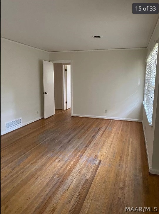 empty room with hardwood / wood-style floors