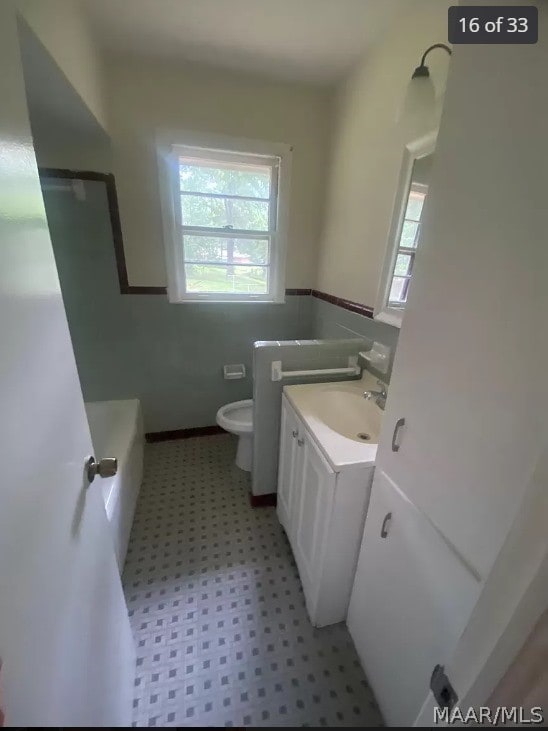 bathroom with vanity, tile patterned flooring, and toilet