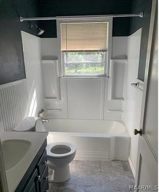 full bathroom with shower / washtub combination, vanity, tile patterned floors, and toilet