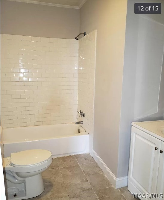 full bathroom featuring tiled shower / bath combo, vanity, ornamental molding, and toilet